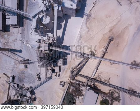 Large Quarry Stone Sorting Conveyor Belts And An Open Pit Mine. Industrial Building.