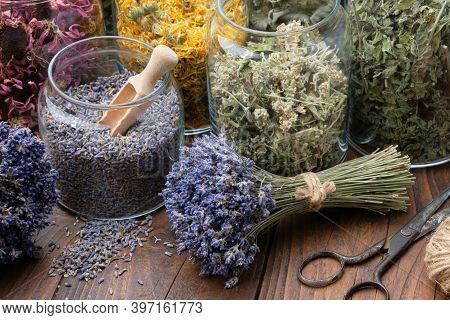 Glass Jar Of Dry Lavender Flowers For Making Herbal Tea, Bunches Of Dry Lavender. Jars Of Different 