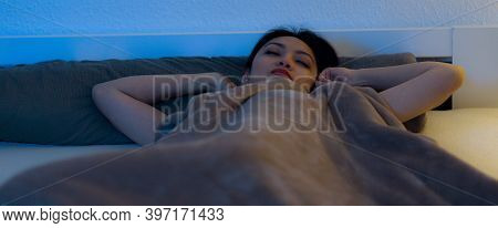 Young Asian Woman Wakes Up While She Lies In Bed - Home Shooting