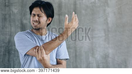 Young Asian Man Having Elbow Pain, Health Care Concep