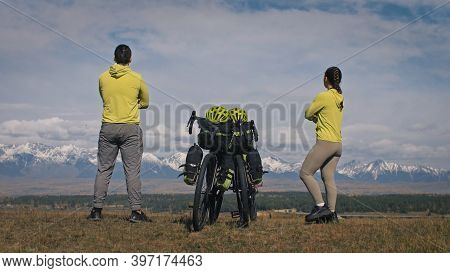 The Man And Woman Travel On Mixed Terrain Cycle Touring With Bikepacking. The Two People Journey Wit