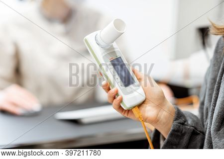 Patient Holding Spirometer, Medical Instrument For Measuring Breathing Movemnts, Close-up