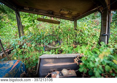 Inside The Abandoned Tractor Cab Covered By Brambles