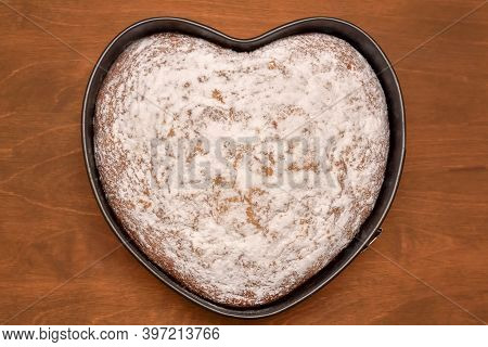 Heart Shaped Cake In Springform Pan Dusted With Powdered Sugar