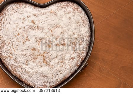 Heart Shaped Cake In Springform Pan, Freshly Baked And Dusted With Powdered Sugar