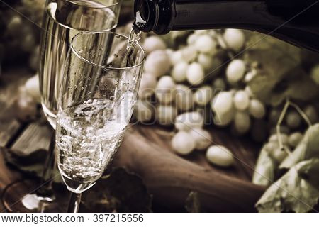 Champagne Pour In Glass, Grapes With Vine, Vintage Wood Background, Black And White, Selective Focus