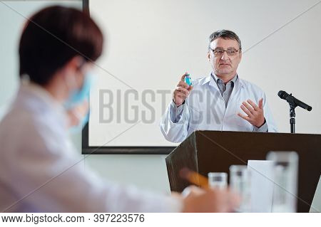 Mature Researcher Speaking At Conference And Explainig How New Vaccine Against Coronavirus Works