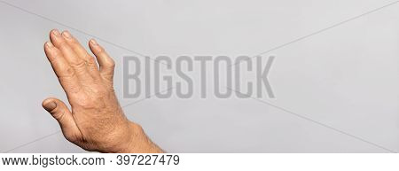 A Human Hand Brush On A Gray Background With Place For Text For Medicine And Traumatology. Ankylosis
