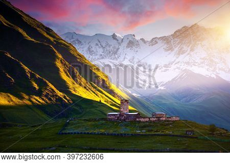 Evening view of the old church Lamaria Jgrag at the foot of Mt. Shkhara. Location place of Ushguli village, Zemo Svaneti, Georgia country, Europe. Main Caucasian ridge. Discover the beauty of earth.