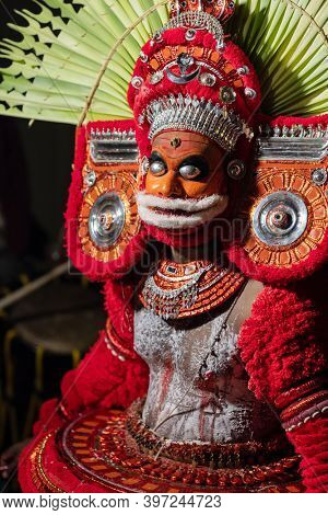 Payyanur, India - December 5, 2019: Theyyam artist perform during temple festival in Payyanur, Kerala, India. Theyyam is a popular ritual form of worship in Kerala, India