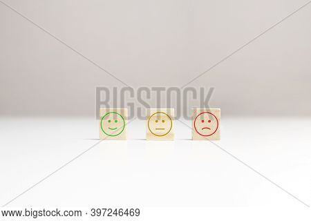 Happy, Calmness, Sad Faces Emotions On Wooden Blocks On Table, Copy Space. Review, Feedback Rating. 