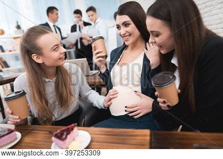 Two Young Girls Are Laughing At Work Annoying Boss. Two Women Are Standing In The Office With Papers