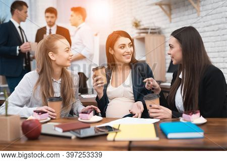 Two Young Girls Are Laughing At Work Annoying Boss. Two Women Are Standing In The Office With Papers