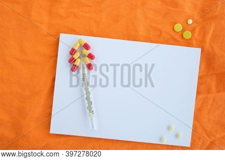 Pills On Orange Background, Conceptual Medical Background With Copy Space. High Quality Photo