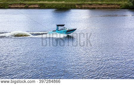 Modern Speedboat Sailing On Forest Background. Summer Leisure And Water Activity. Rest On The River 