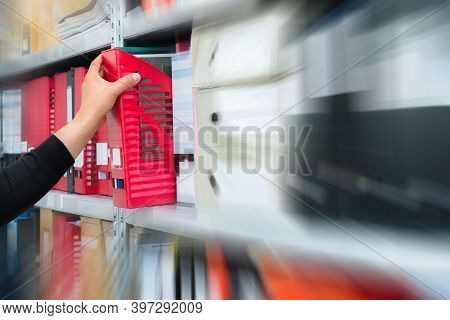 Mans Hand Picking A Blank Blind Folder With Files From The Shelf. Archival, Stacks Of Documents At T
