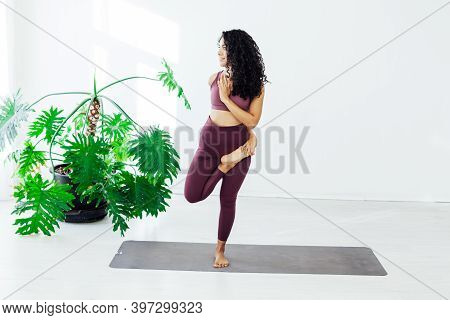 Beautiful Female Brunette Yoga Asana Stretching The Flexibility Of The Body Fitness Gym Gym