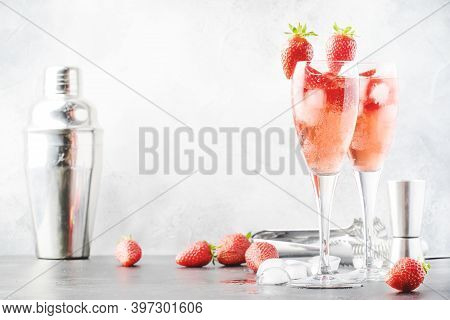 Rossini Alcoholic Cocktail With Italian Sparkling Wine, Strawberry Puree And Ice In Champagne Glasse