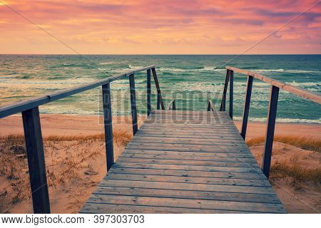Wooden Staircase With A Handrail On The Seashore