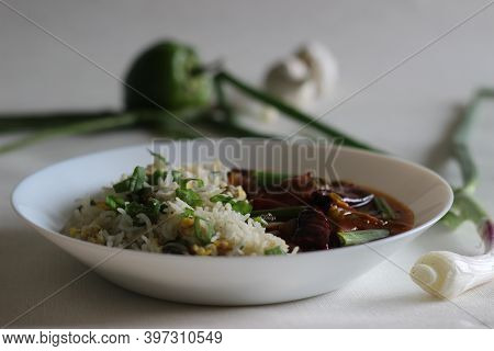 Egg Fried Rice And Chilli Garlic Chicken Gravy, Prepared In Indo-chinese Style