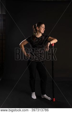 Fitness Rests On The Bodybar Stretches The Arms. Go In For Sports On A Black Background With Beautif