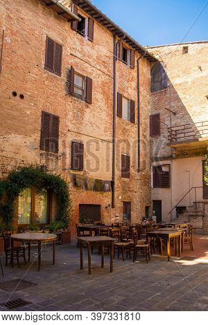 Buonconvento, Italy - September 3rd 2020. A Outdoor Restaurant Bar In The Centre Of Historic Medieva