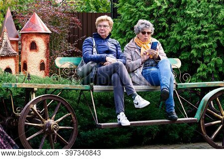 Two Women Tourists Are Resting On A Cart.puppet Museum, July 2020 In Preili, Latvia