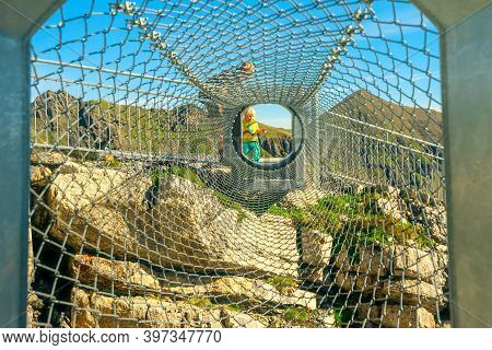 Birg, Murren, Switzerland - Aug 19, 2020: Child Walks The Tube Made Of Nets Of Thrill Walk On Schilt