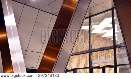 Combination Of Metal And Glass Wall Material. Steel Facade On Columns. Abstract Modern Architecture.