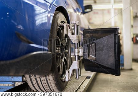 Car In Service With Sensors On The Wheels To Check Alignment Camber Toe