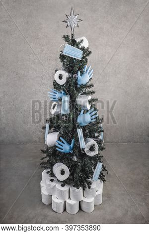 Holiday Christmas tree decorated with toilet paper, rubber gloves and face masks in honor of the medical community