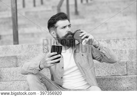 Drink It On The Go. Brutal Hipster Drink Coffee Sitting On Stairs. Bearded Man Enjoy Hot Drink Outdo