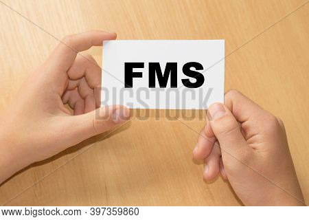 Card With Text Fms On Hand. Factory Management System - Business Concept
