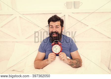 Happy Wake Up Of Man Lying In Bed With Alarm Clock. Guy Is Waking Up. Alarm Clock In The Morning. Ma