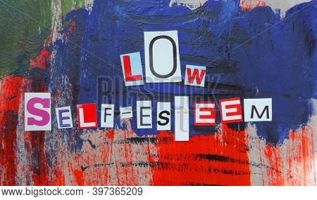Cut Out Of Letters Magazines Compiled The Word Low Self-esteem On An Abstract Colorful Background