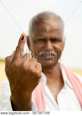 Selective Focus On Hand, Indian Farmer Showing Ink Marked Finger After Voting During Indian Election