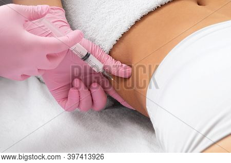 A Doctor Of Aesthetic Cosmetology Makes Lipolytic Injections To Burn Body Fat On A Woman's Stomach A