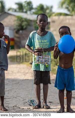 Ghana Children Showing Off Their Toys Handcrafted From Cardboard And Bottle Caps, Picture Taken In K