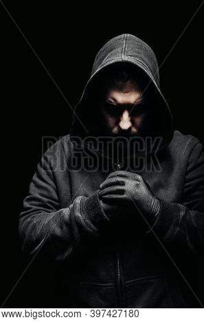 Photo Of A Creepy Vile Criminal In Hoodie Standing In Dark.