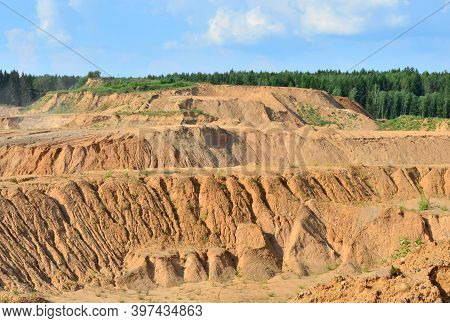 Background Of Mountain Showing Yellow Soil And Rock. View On The Canyon With Cracks In Sand. Mining 