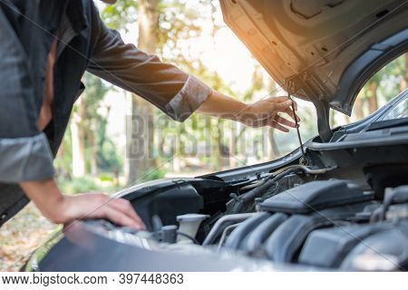 Close Up Hand Man Open Car Hood For Repair As Maintenance Service. Man Trying To Repair A Car Engine