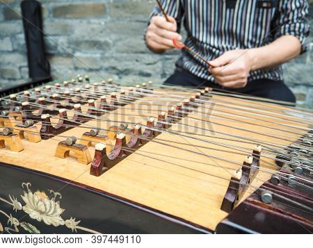 Old Man Playing With Bamboo Hammers On A Modern Yangqin With Five Courses Of Bridges, Beijing, China