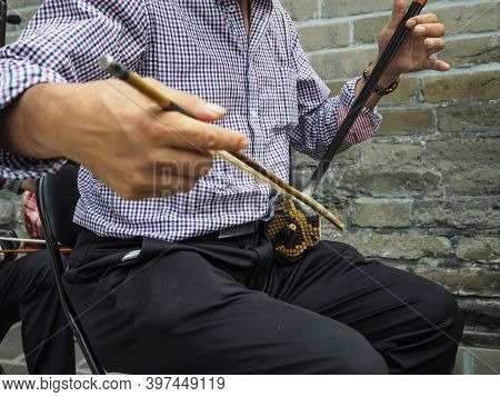 Chinese Man Playing The Chinese Violin Called Erhu In A Small Ensemble Outdoor At The Temple Of Heav