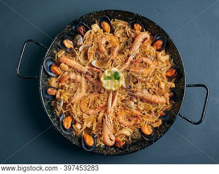 Fideua, Noodle Paella With Seafood On Rustic Background, Top View