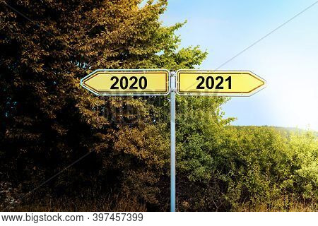 Yellow Road Signs In Opposite Directions With Text 2020 And 2021, Pointing To A Brighter Future, New