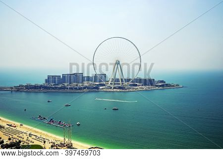 Dubai, Uae - 08.15.2020: Dubai Eye Ferris Observation Wheel During Day In Blue Tones With Boats, Vie