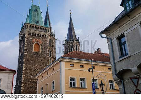 Medieval Stone St. Bartholomew´s Church With Belfry Tower, Gothic Cathedral At The End Of Narrow Str