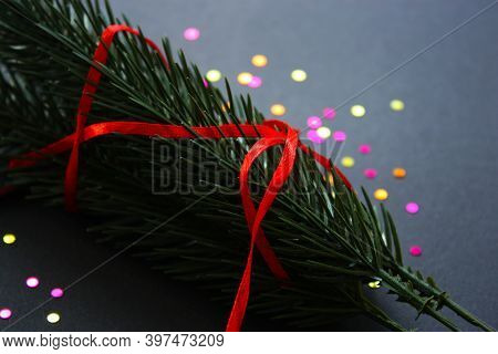 Vibrant Christmas, New Year 2021 Deecorations. Twigs Of Green Spruce Tree With Thin Red Ribbon. Circ