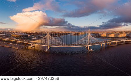 Aerial Panoramic View To Evening St. Petersburg And Cable-stayed Bridge Across Petrovsky Fairway. We