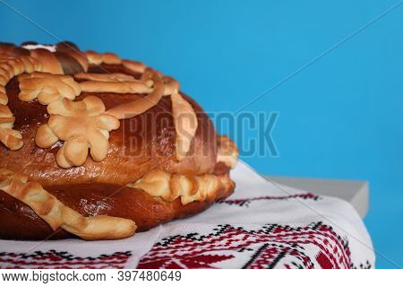 Rushnyk With Korovai On Light Blue Background, Closeup. Ukrainian Bread And Salt Welcoming Tradition